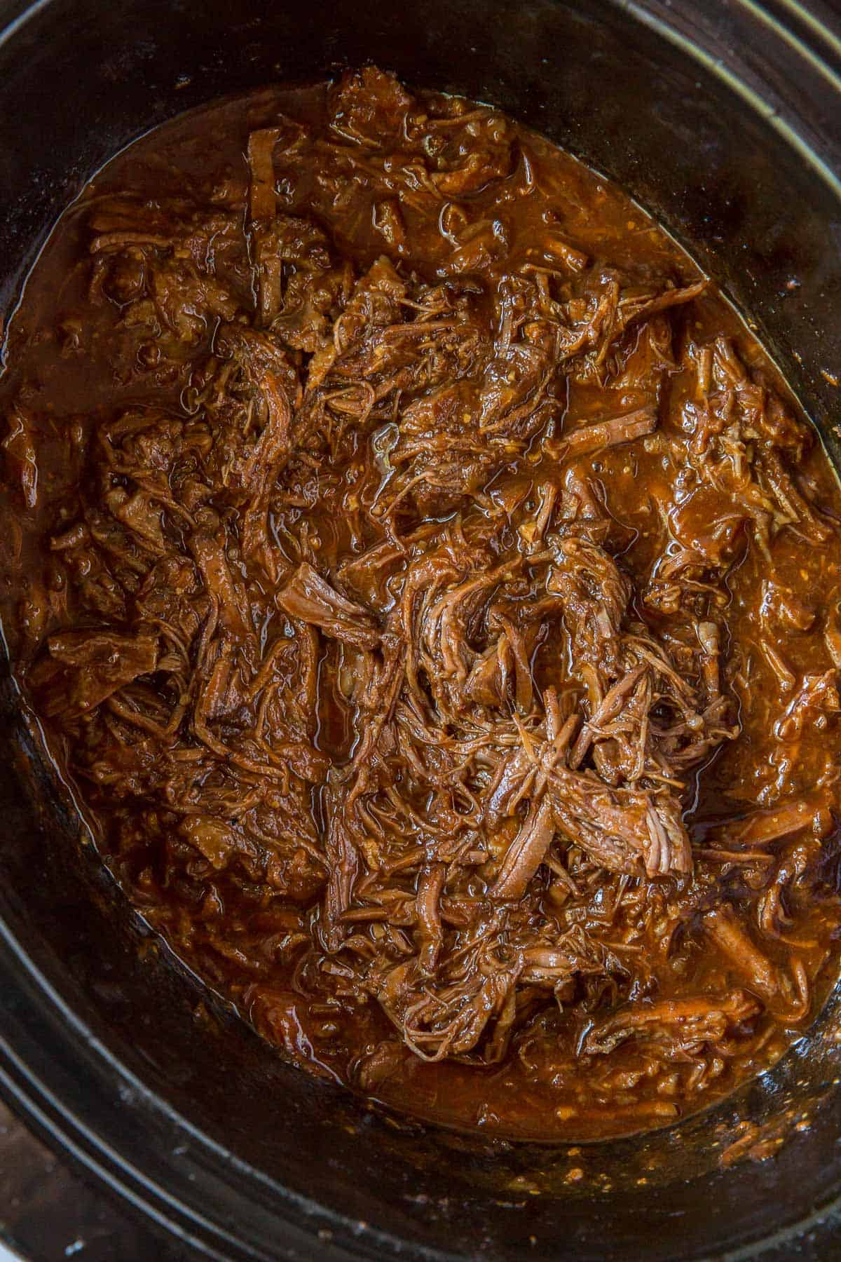 Shredded barbecue beef in a crock-pot.