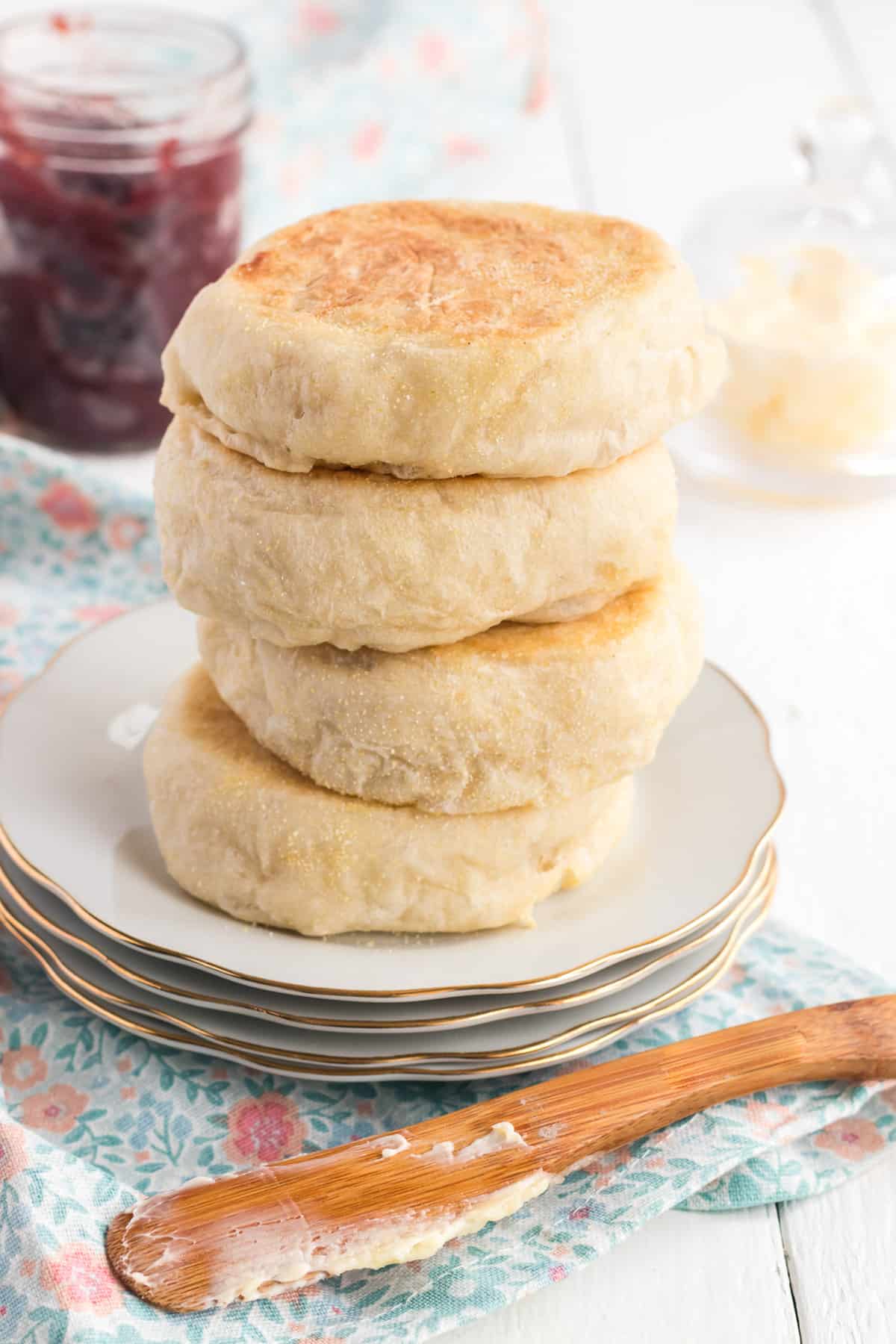 A stick of four English muffins on a plate.