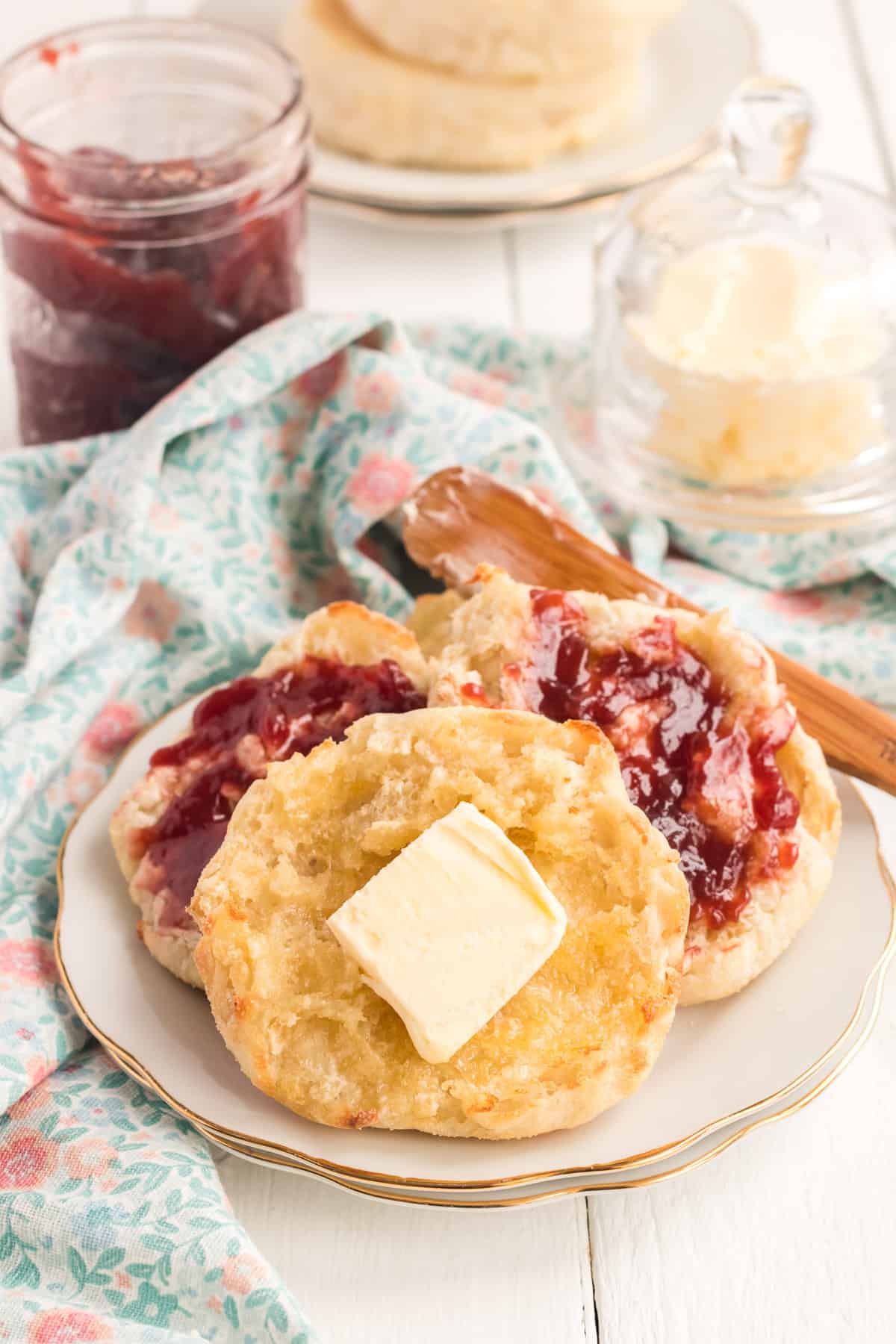English muffins with jelly and a pat of butter.