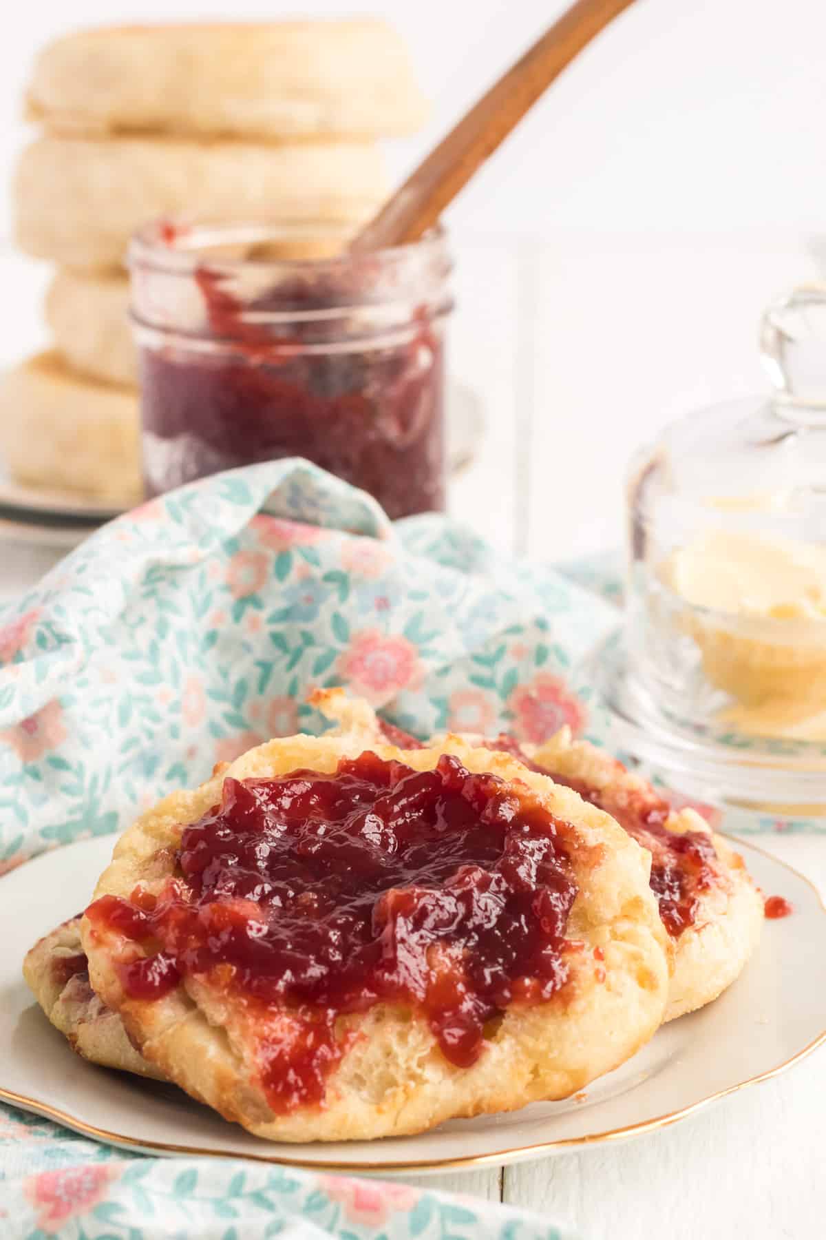 English muffins on a plate with jelly.