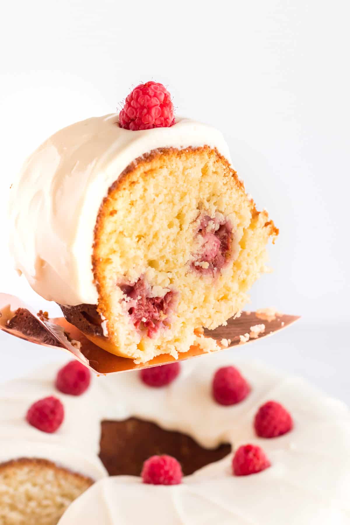A slice of the Bundt cake is lifted with a spatula.
