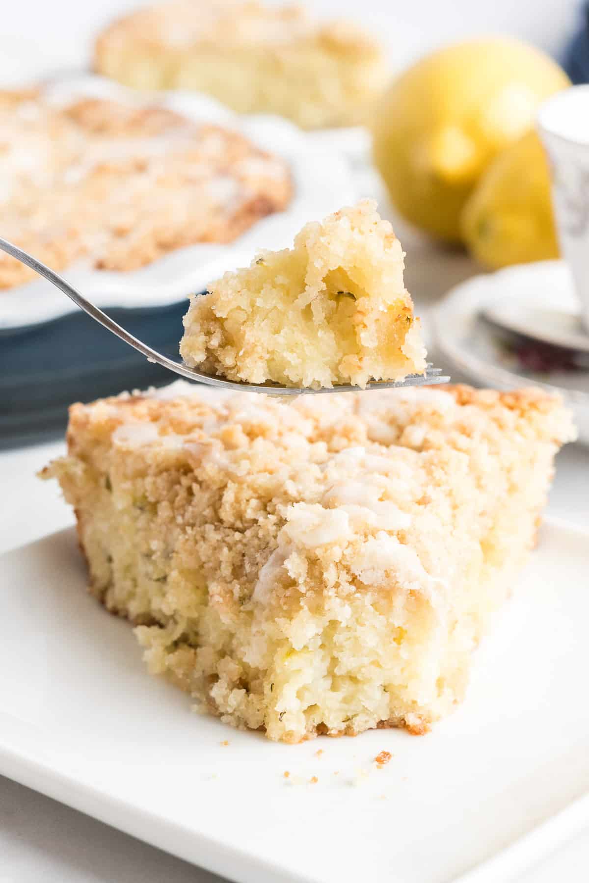 A fork lifts up a bite of the coffee cake.