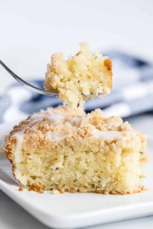 A fork lifts a bite of Lemon Zucchini Coffee Cake.