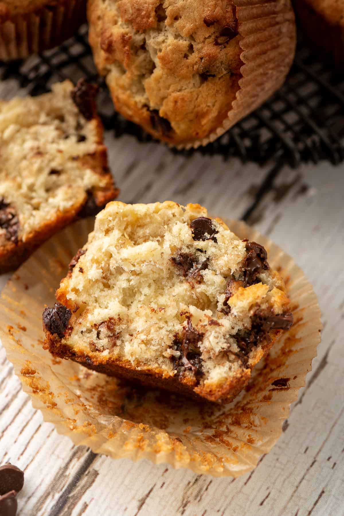 A closeup of half of an Oatmeal Banana Muffin in a cupcake liner.