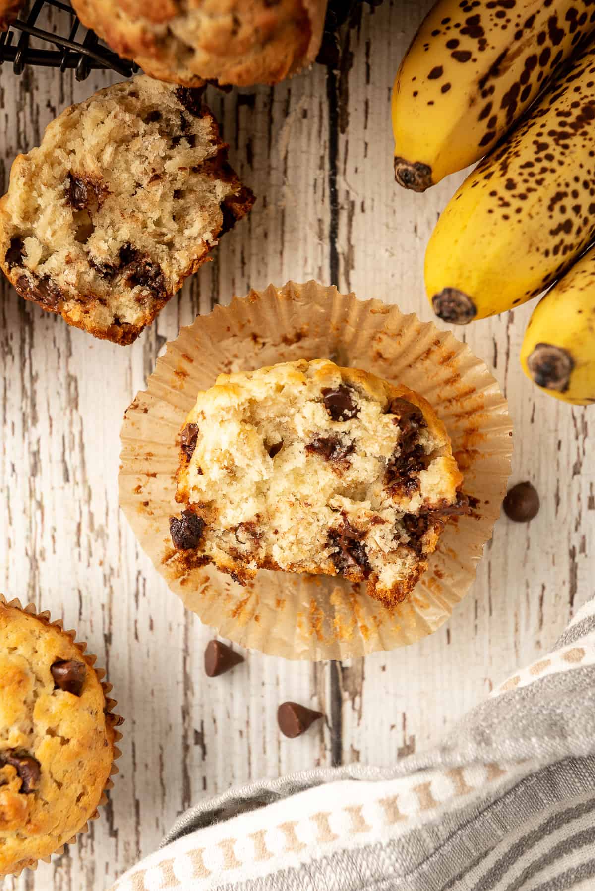 A Oatmeal Banana Muffin cut in half revealing the chocolate chips inside.