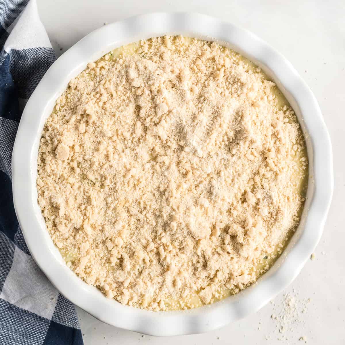 Lemon zucchini coffee cake batter topped with crumb topping before baking.