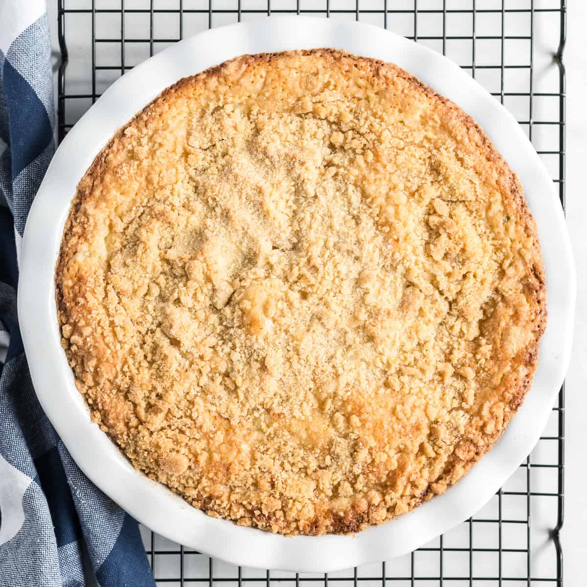 Baked lemon zucchini coffee cake cooling on a wire rack.