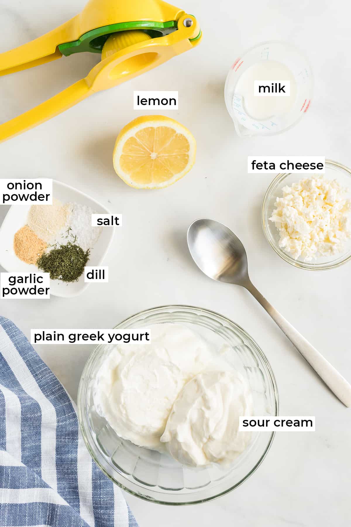 All the ingredients for Feta Dill Sauce on a white counter with text overlay.