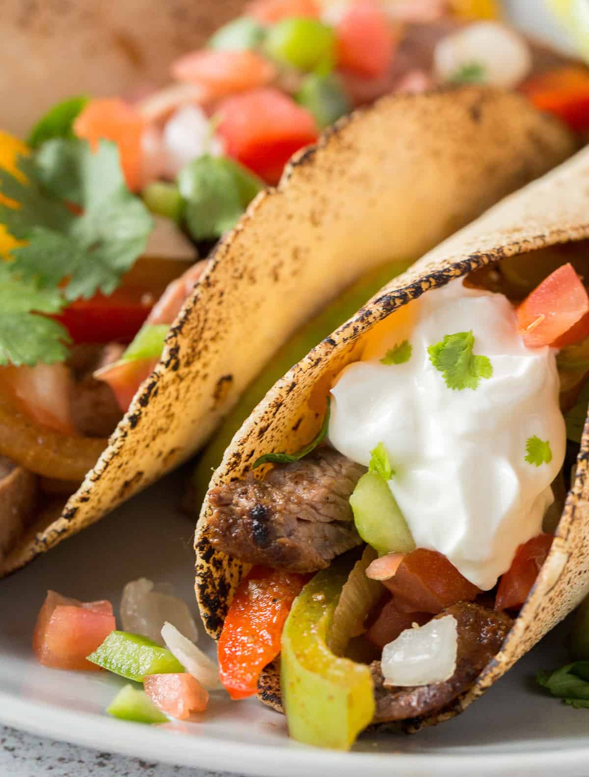 A tortilla stuffed with grilled steak, vegetables and sour cream.