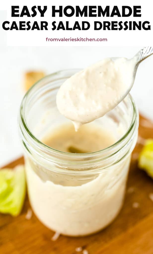 A spoon scoops Caesar Salad Dressing from a mason jar with text overlay.