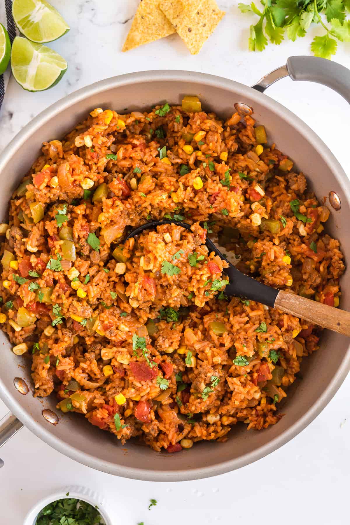 One Pot Spanish Rice in a skillet with a spoon.
