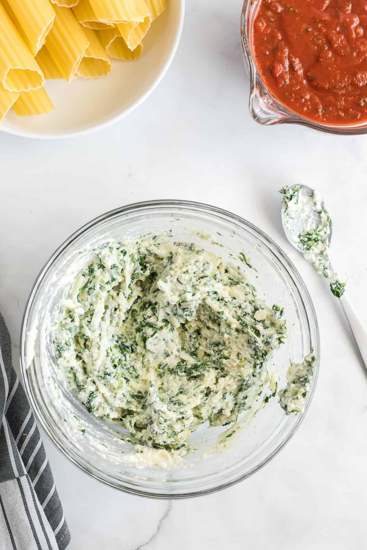 A ricotta spinach mixture in a large glass bowl.
