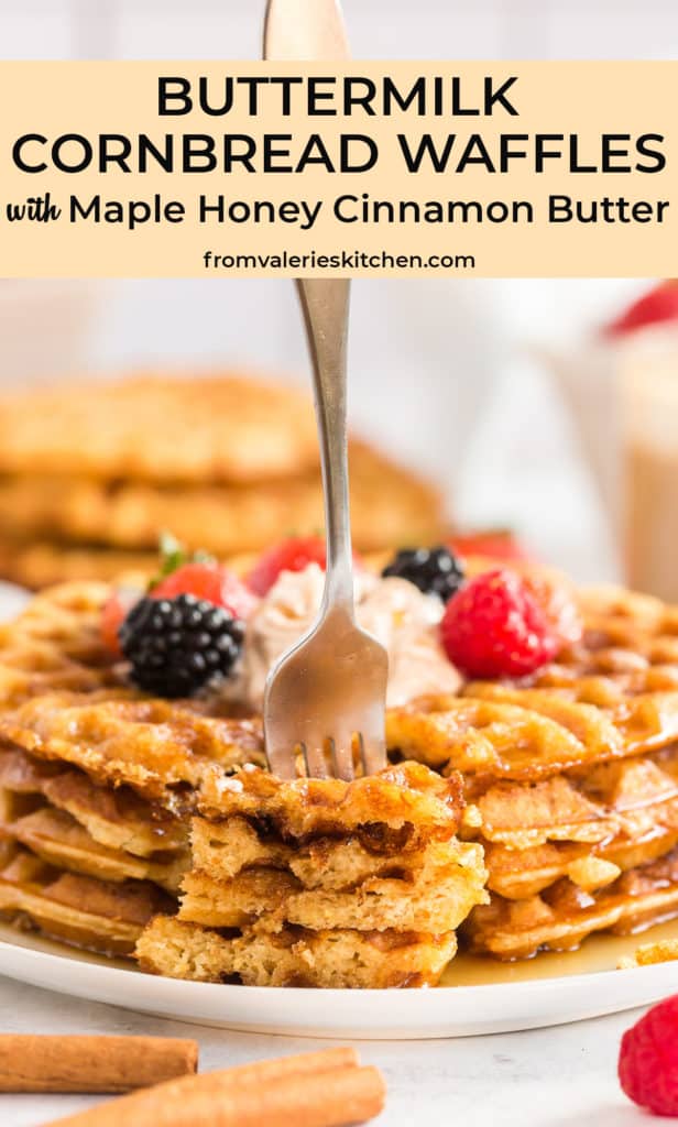 A fork pressing into a stack of waffles topped with berries and syrup with overlay text.