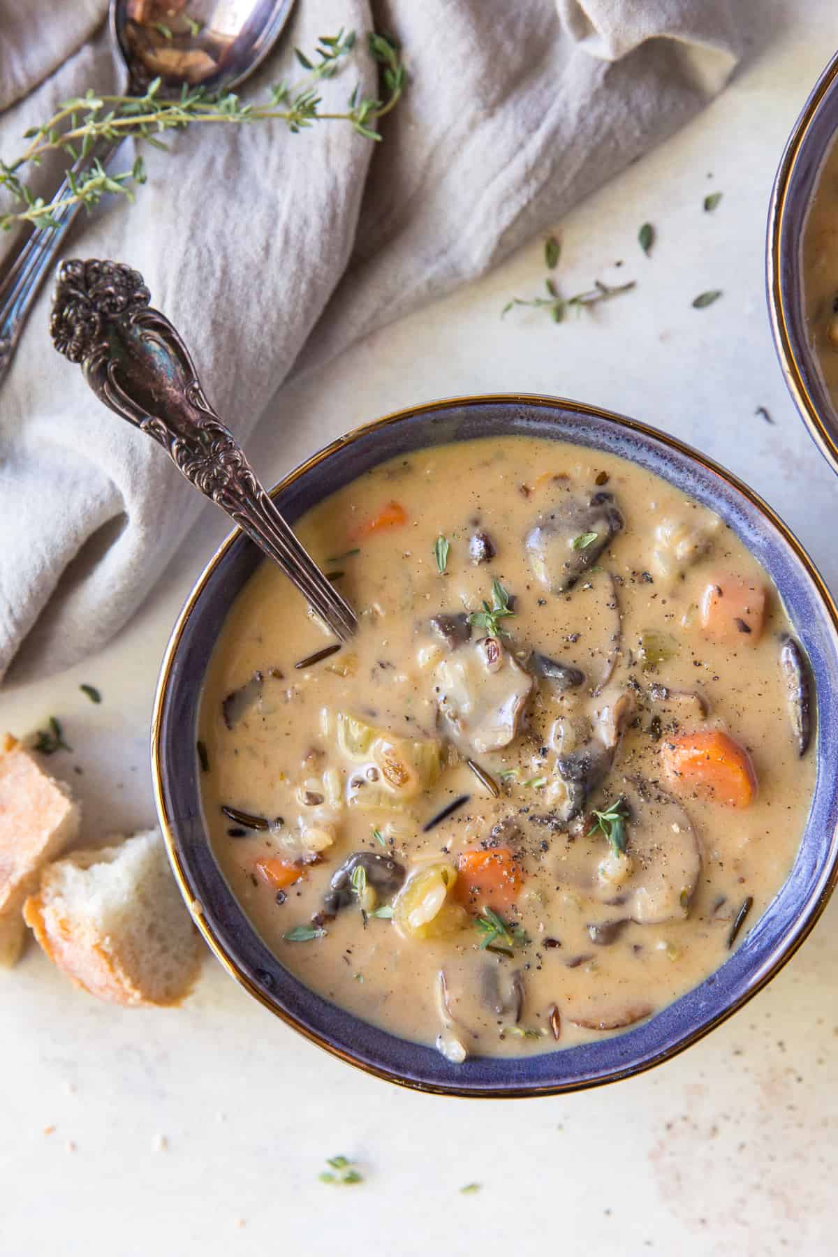 A bowl of soup with mushrooms and wild rice.