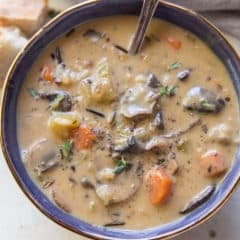 A close up image of a bowl of mushroom wild rice soup.