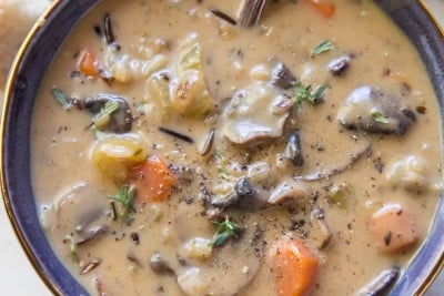 A close up image of a bowl of mushroom wild rice soup.