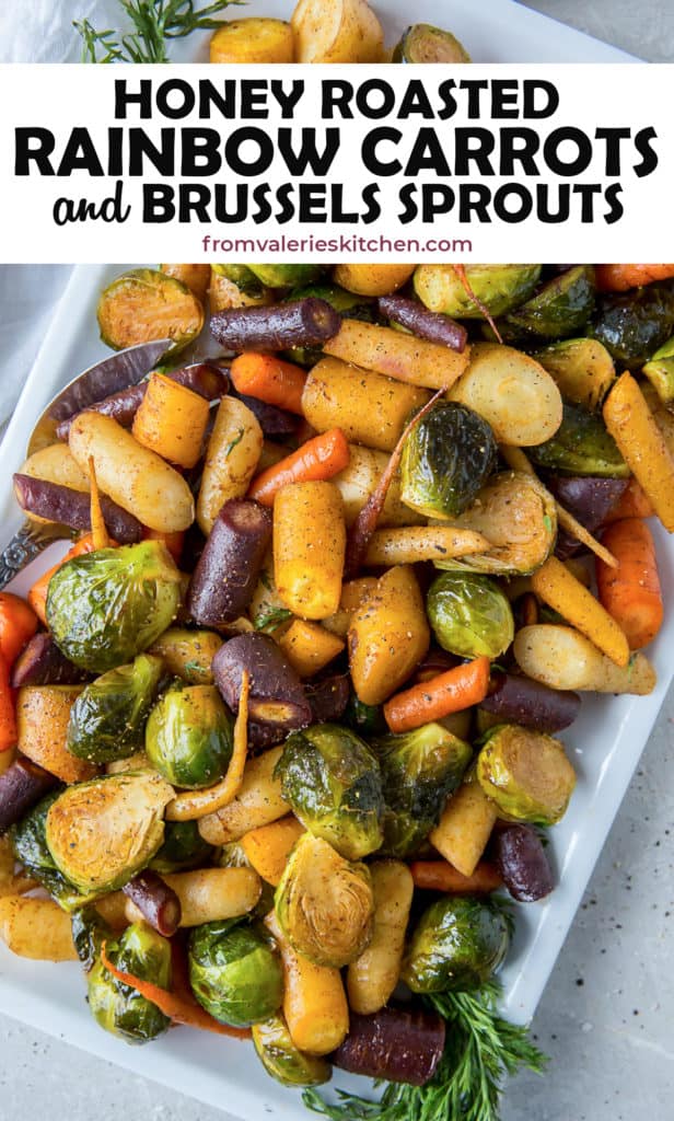 Honey Roasted Rainbow Carrots and Brussels Sprouts on a white platter with text overlay.