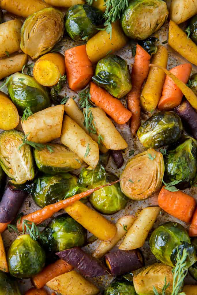 A close up of roasted carrots and Brussels sprout.s