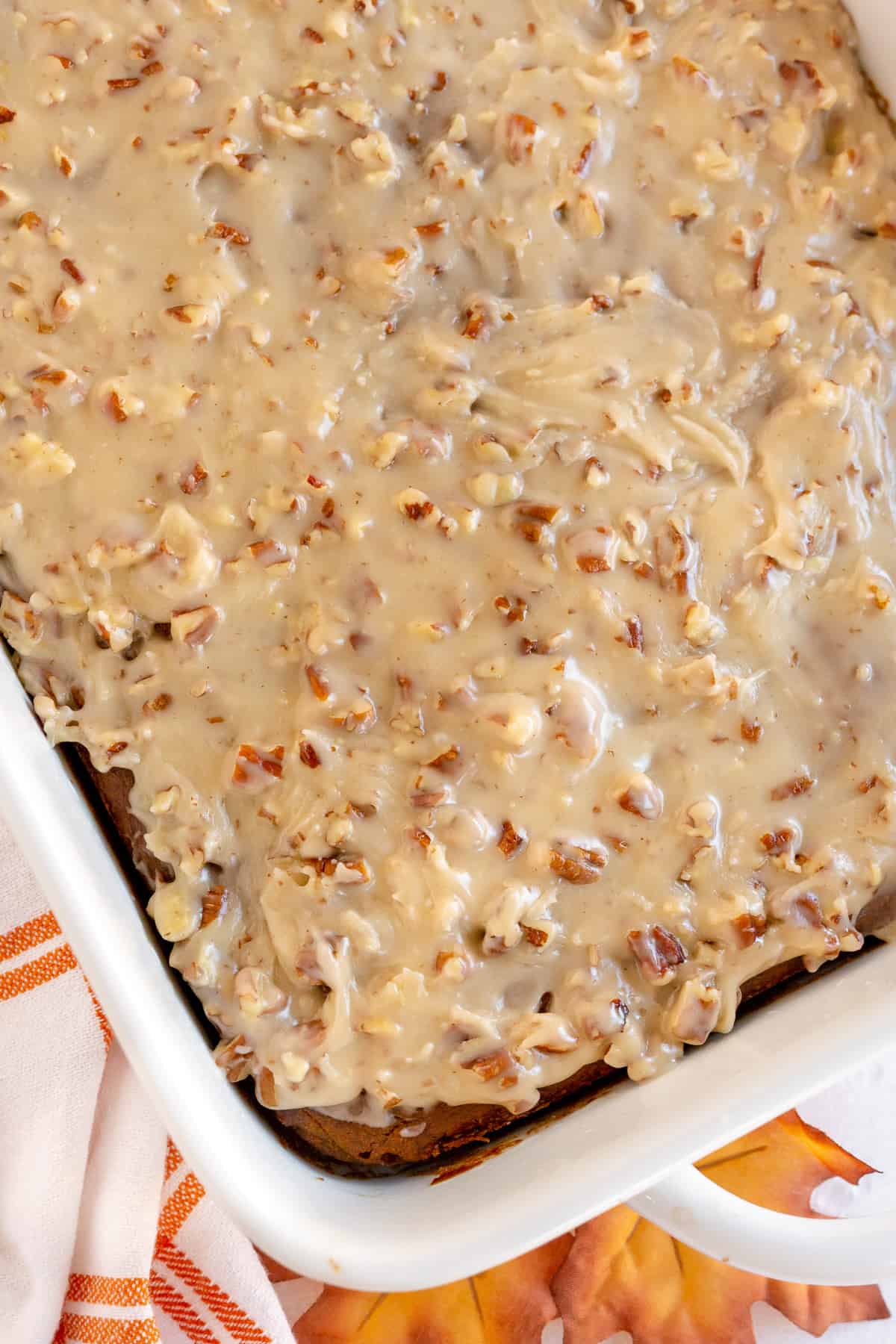 An over the top shot of gingerbread in a baking dish with Maple Pecan Icing.