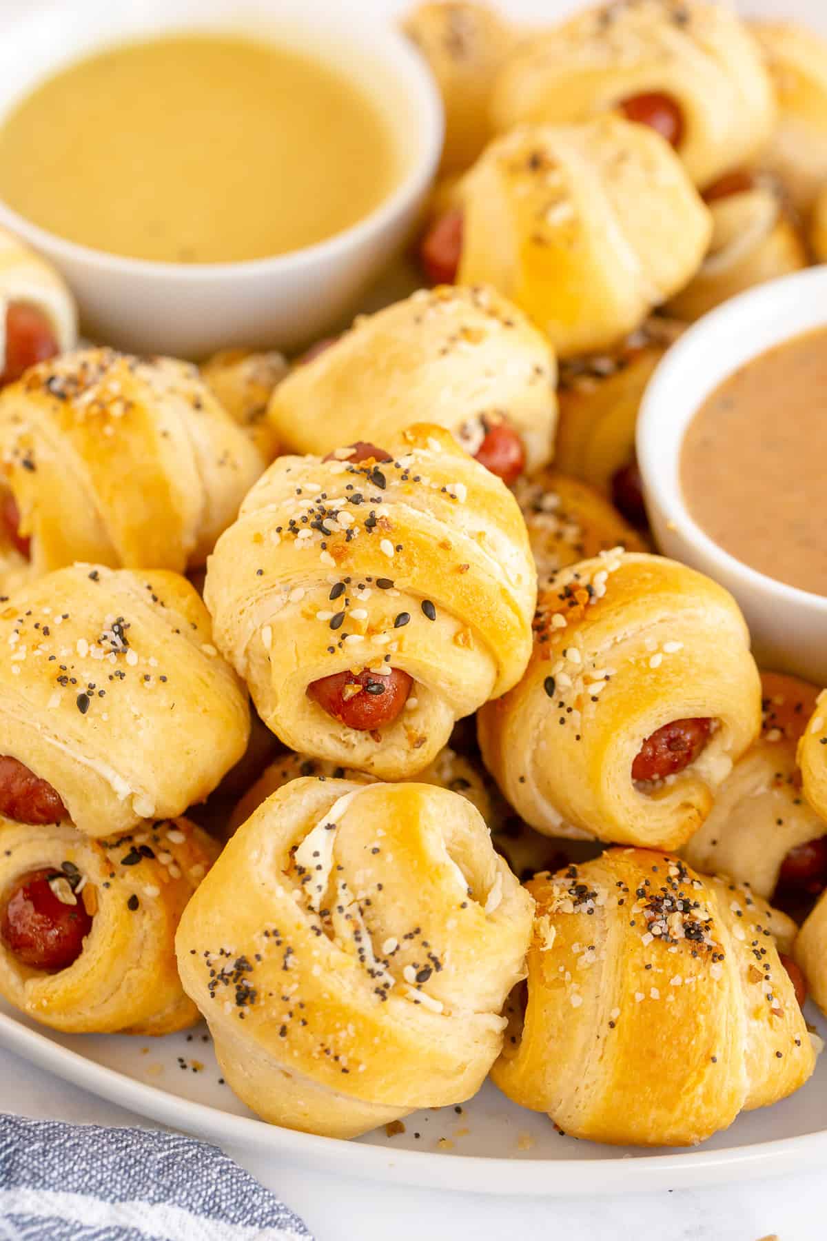A pile of pigs in a blanket topped with everything bagel seasoning.