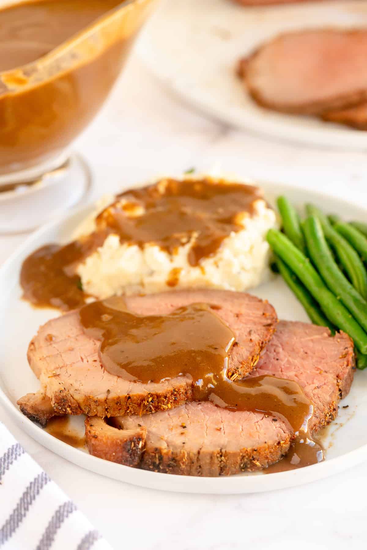 Slices of roast beef and mashed potatoes topped with gravy.