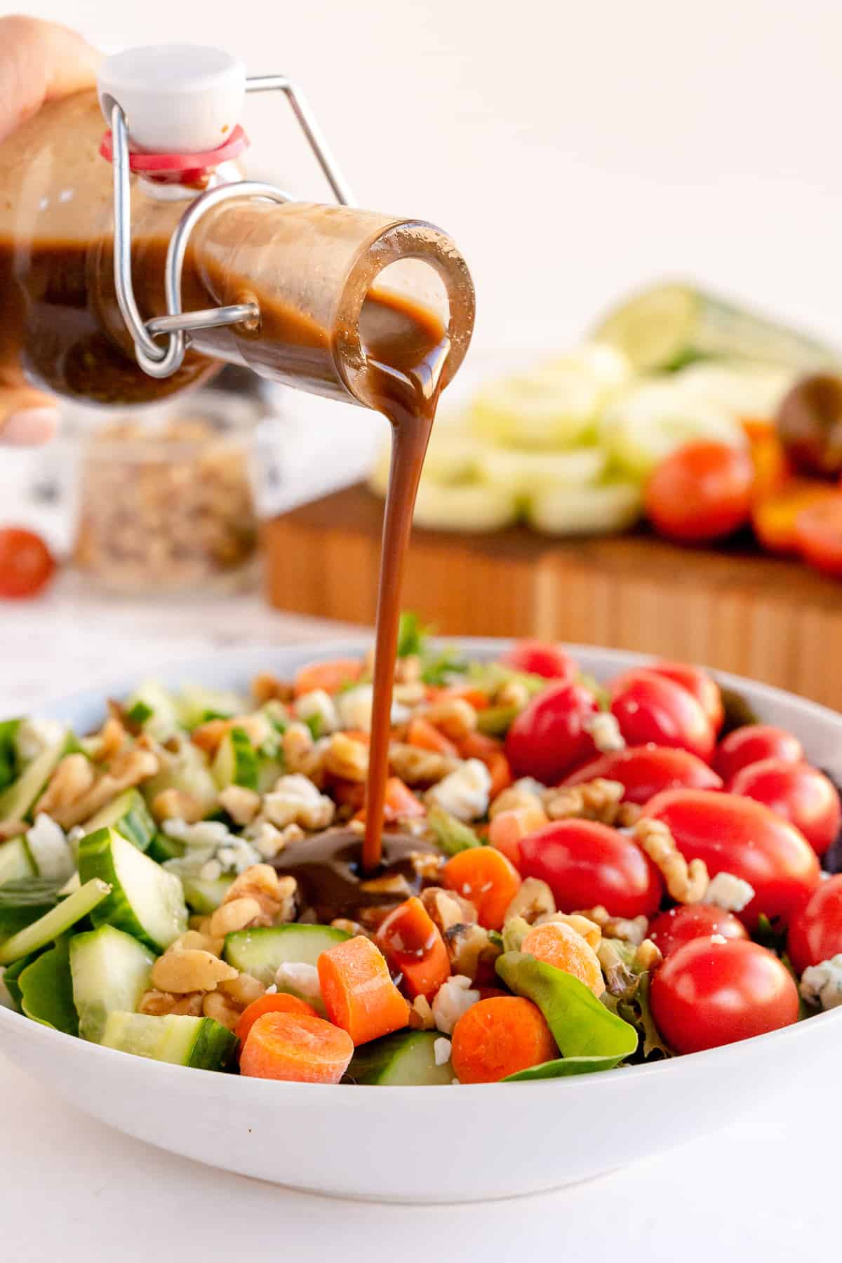 Vinaigrette pouring on to a salad.