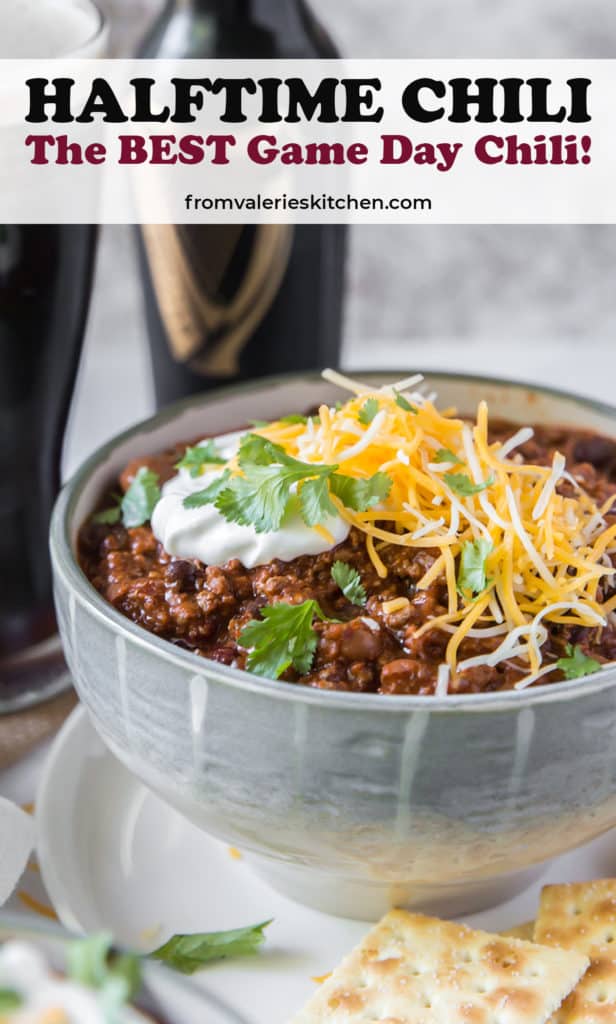 A bowl of chili with beer in the background with text overlay.