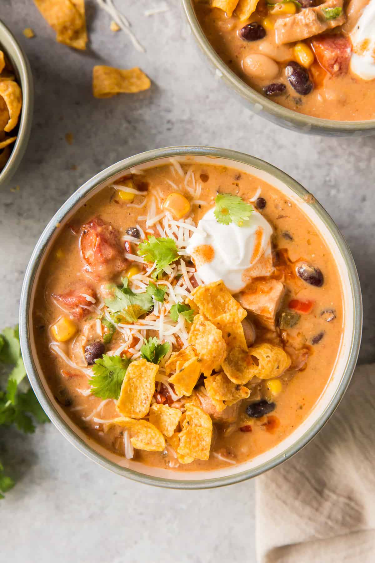 A bowl of creamy chicken soup shot from over the top.