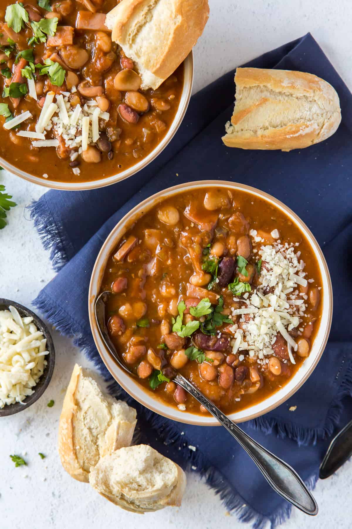 Two bowls of bean soup shot from over the top.