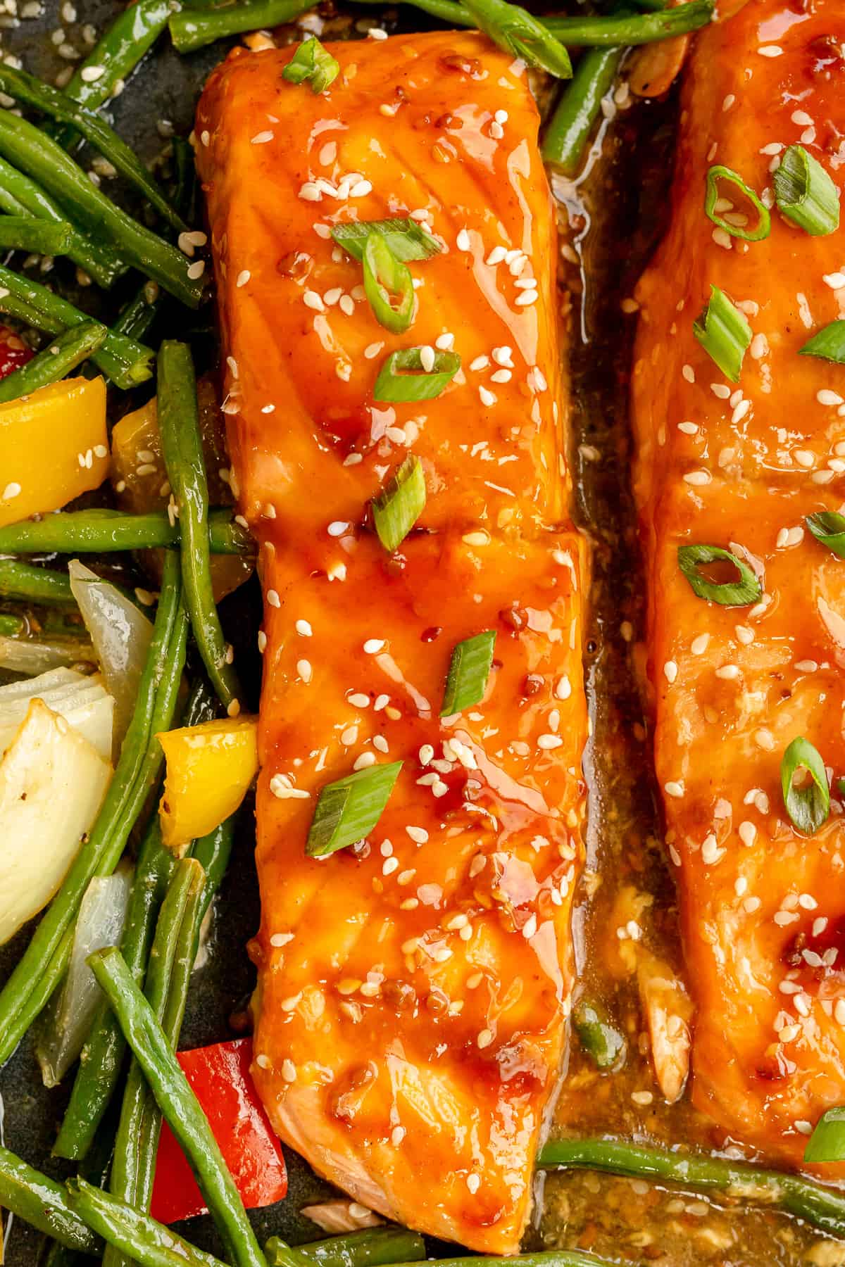 A close up of cooked teriyaki salmon on a sheet pan.