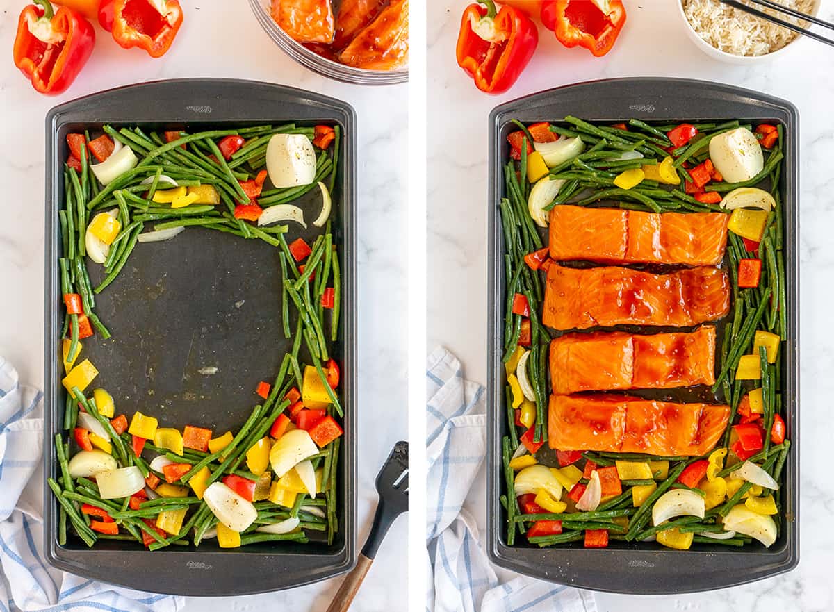 Veggies are spread out on a baking sheet and salmon is placed in the empty space.