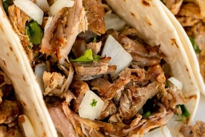 A closeup of a carnitas taco.