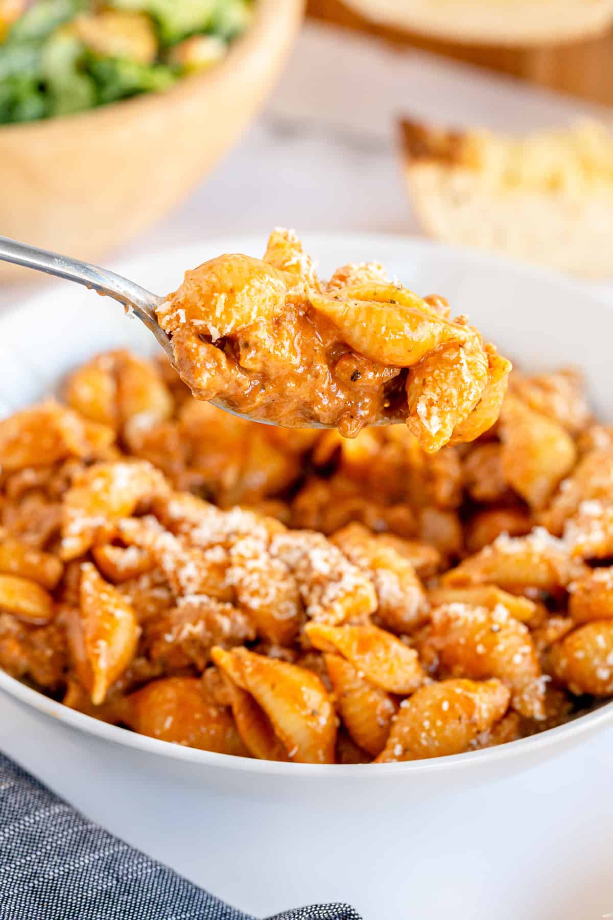 A fork lifts a bite of Creamy Beef and Shells from a bowl.