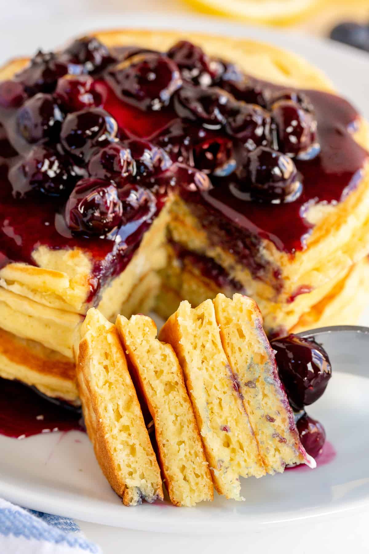 A close up of fork full of Lemon Ricotta Pancakes.