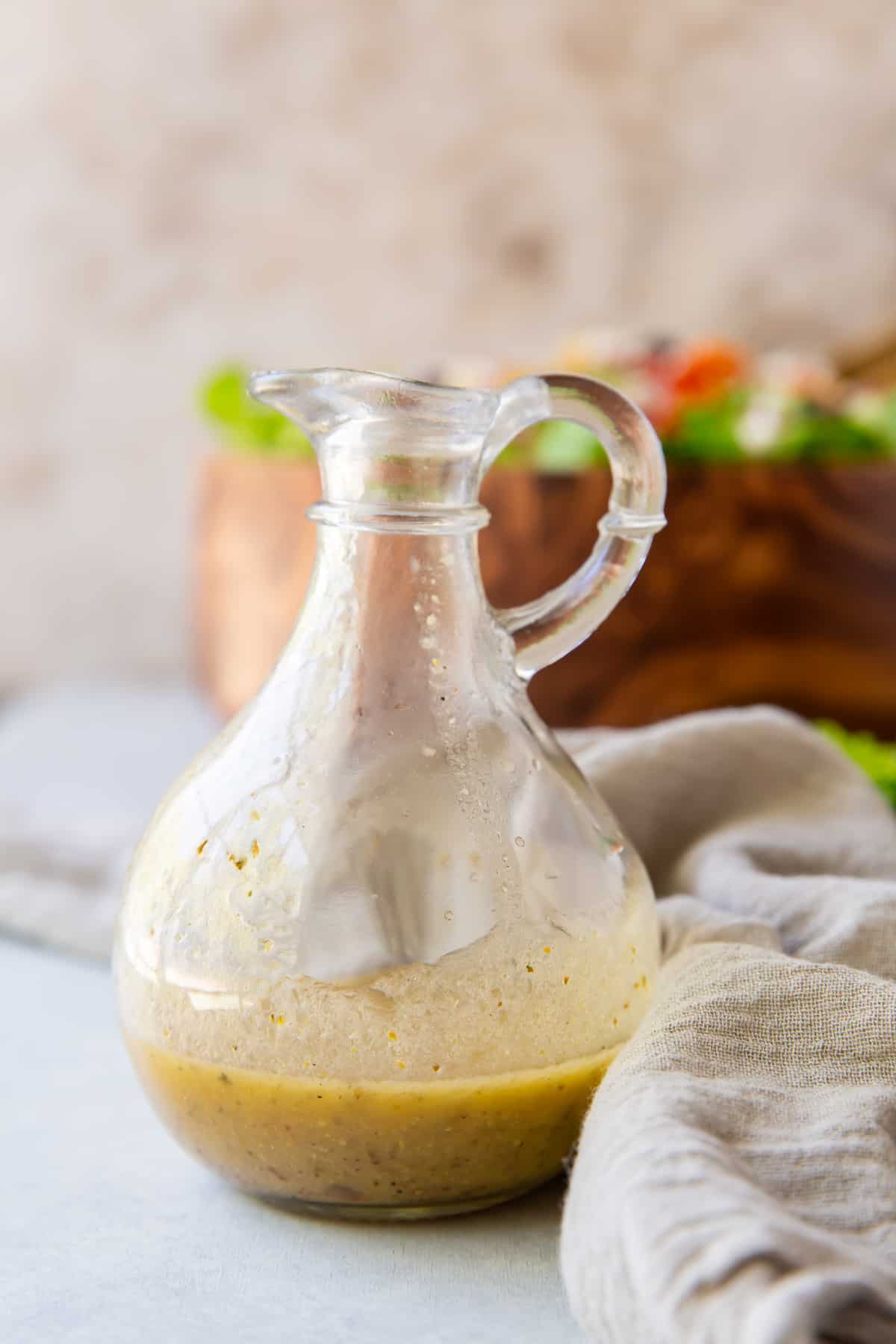 Greek salad dressing in a cruet.