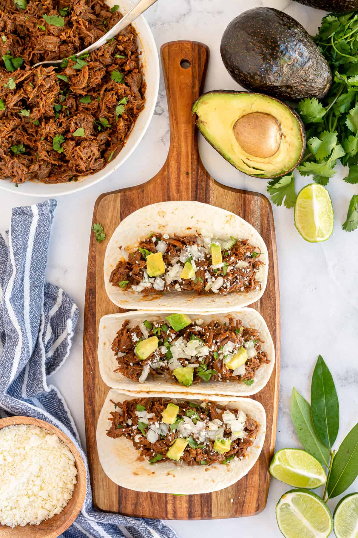 Three soft tacos on a cutting board shot from over the top.