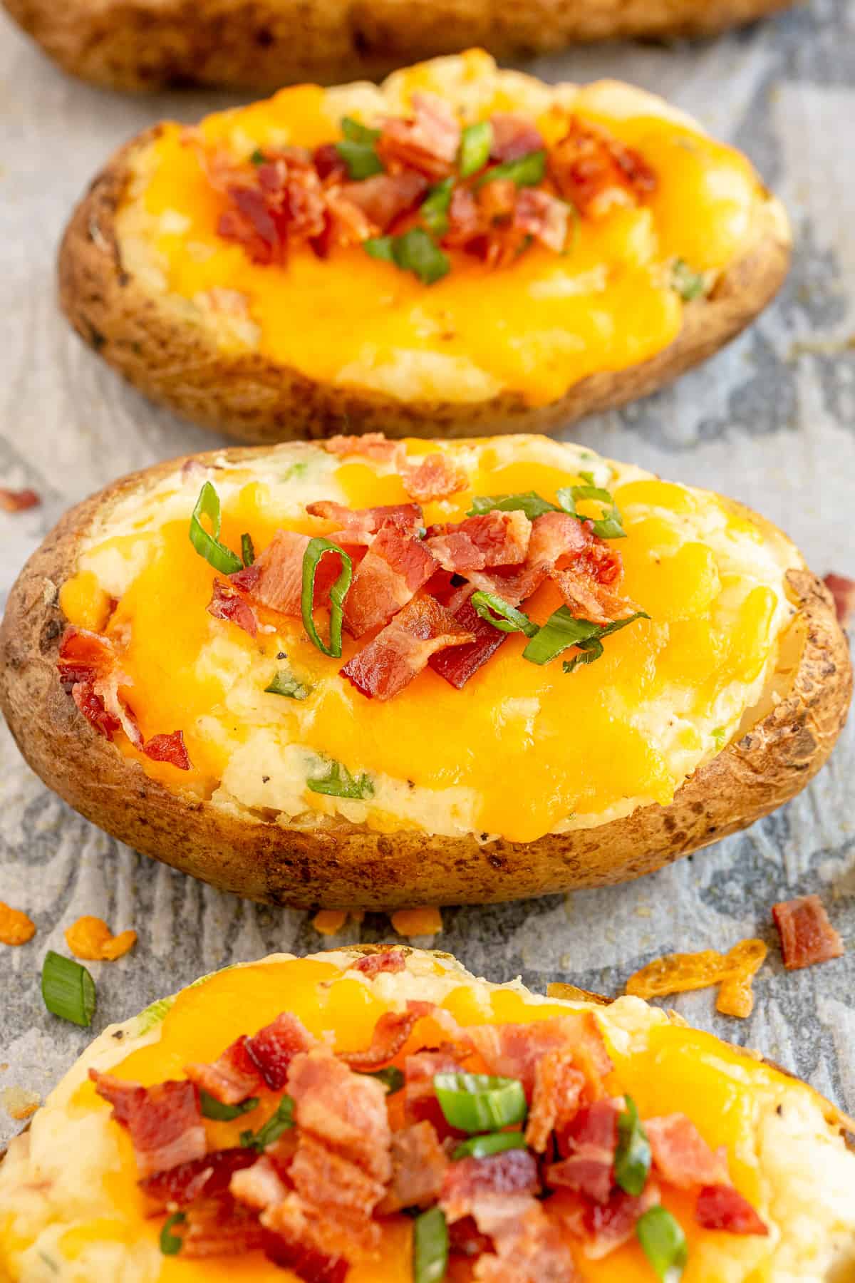 Twice Baked Potatoes on a baking sheet lined with parchment paper.