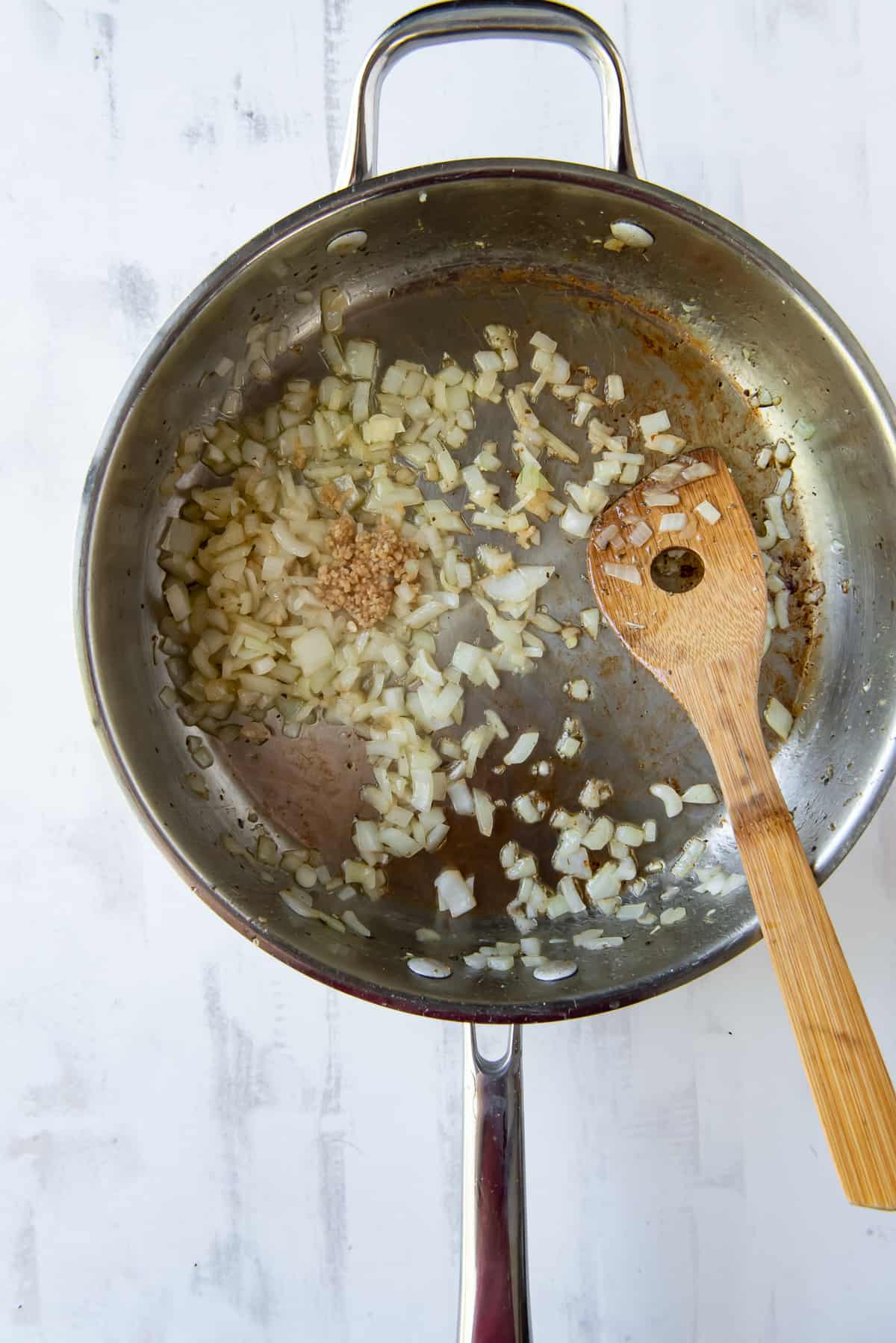 Onion and garlic cooking in a skillet.