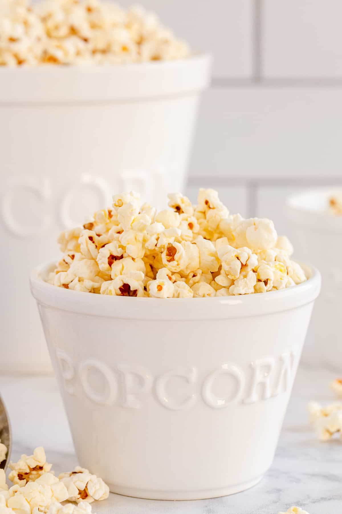 A large and small bowl filled with popcorn.