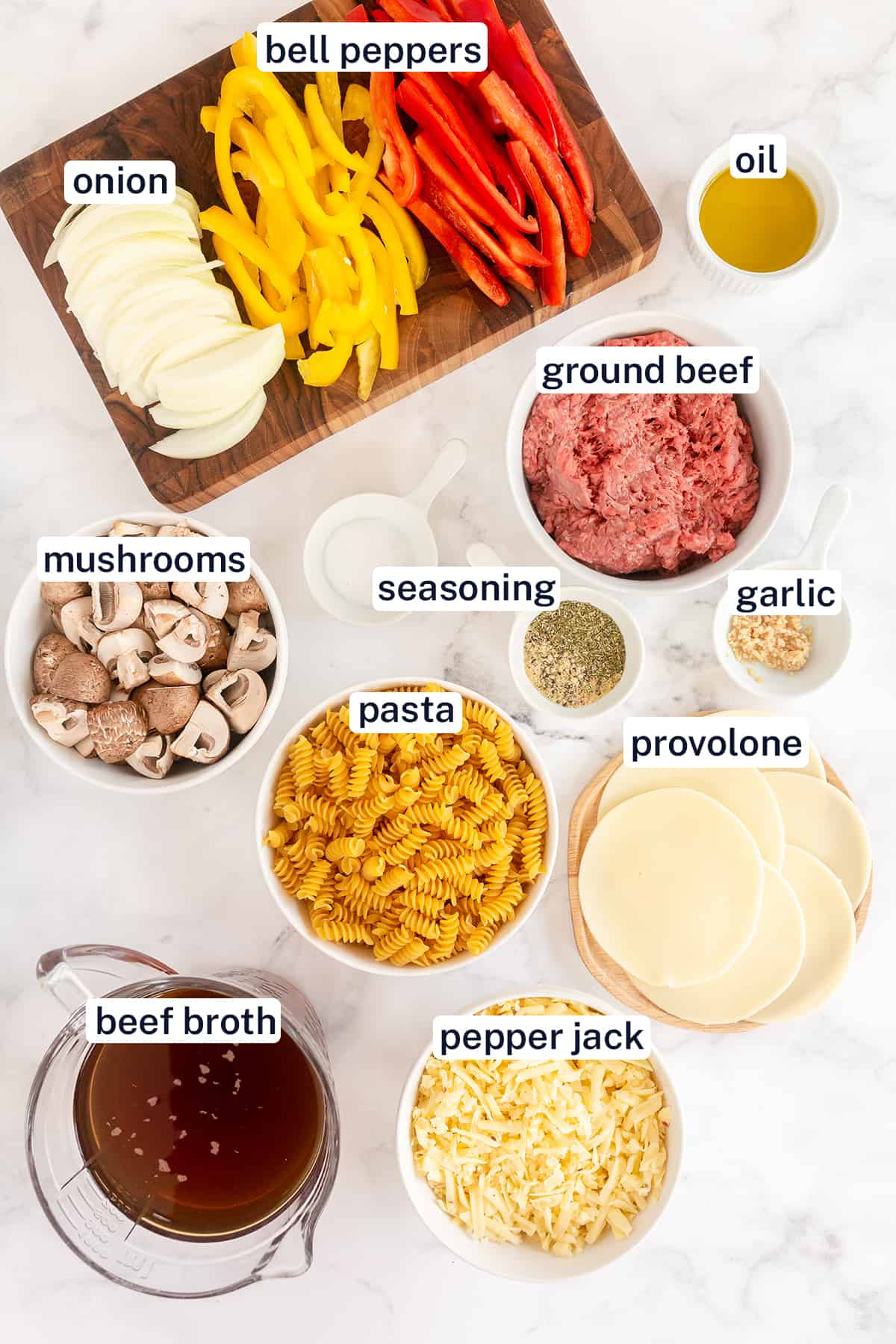 The ingredients for making Philly Cheesesteak Pasta with text overlay.