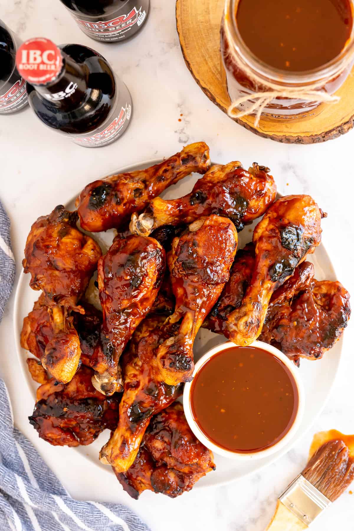 A platter of BBQ chicken with BBQ sauce.