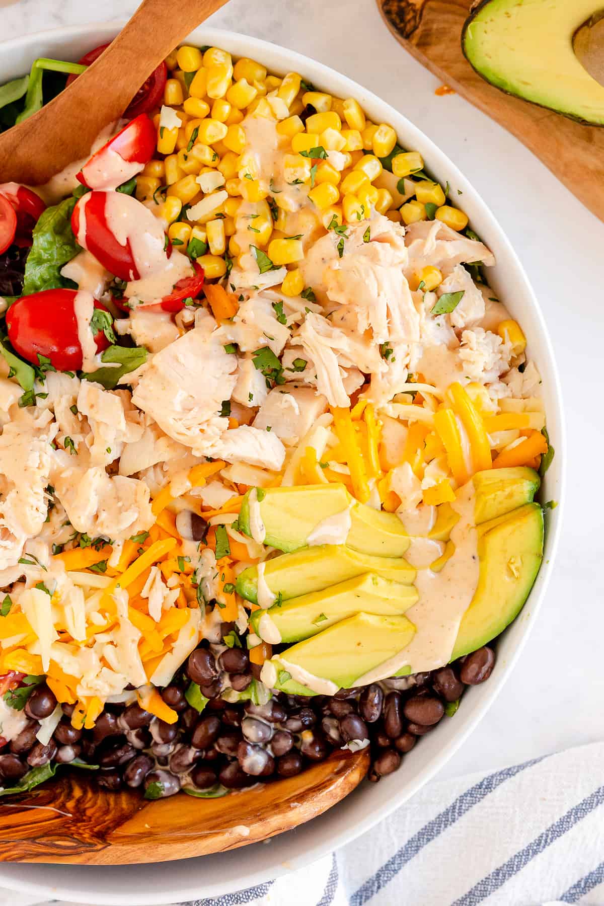 Southwest Chicken Caesar in a bowl with dressing over the top.