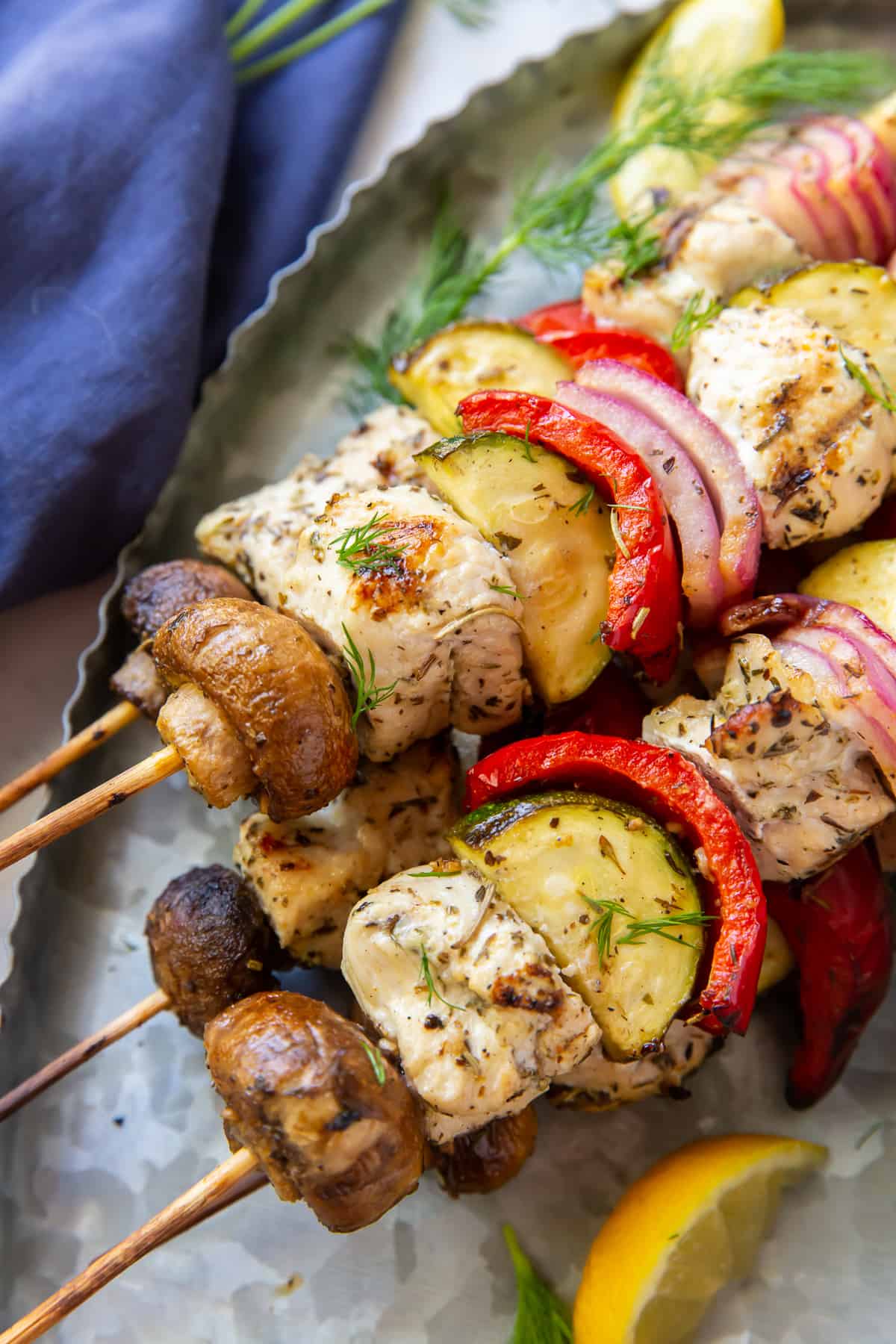 A closeup of Greek Chicken and vegetable kabobs.