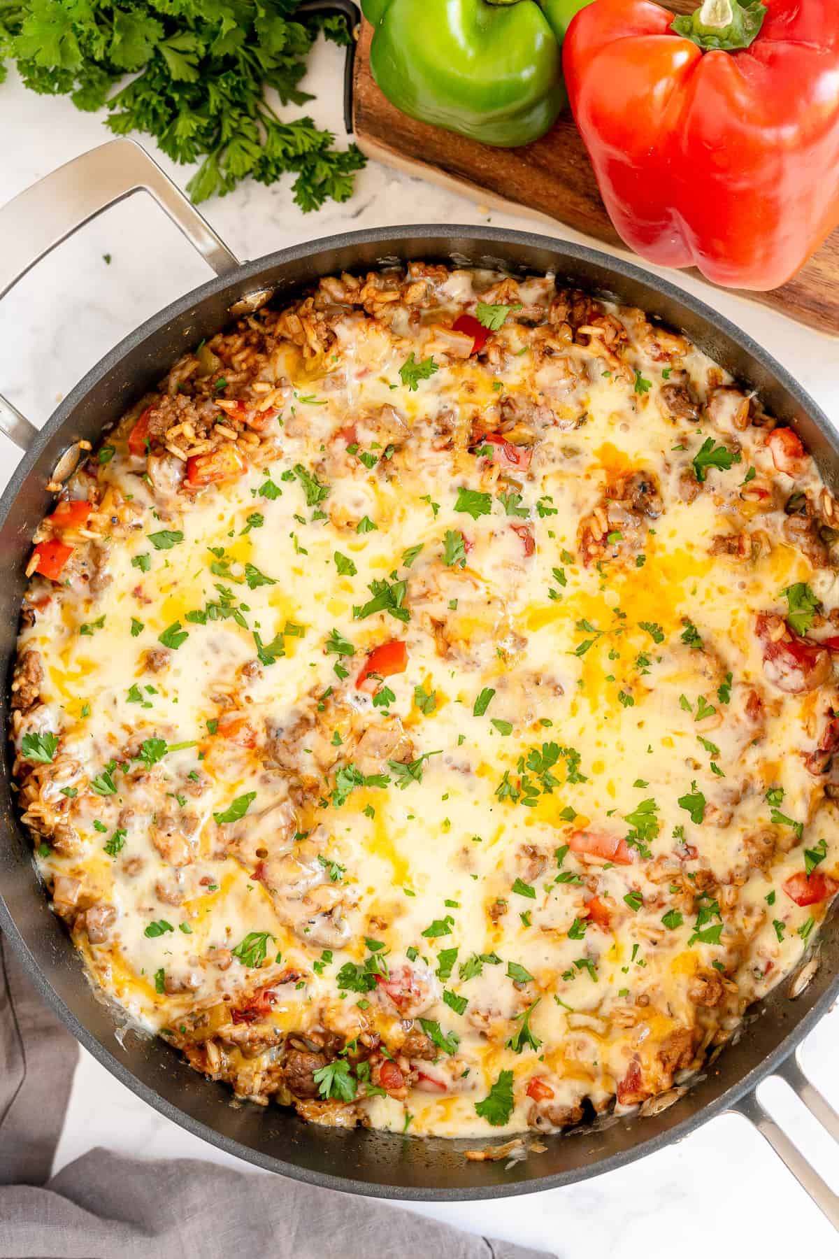 Cheesy ground beef rice and peppers in a skillet.