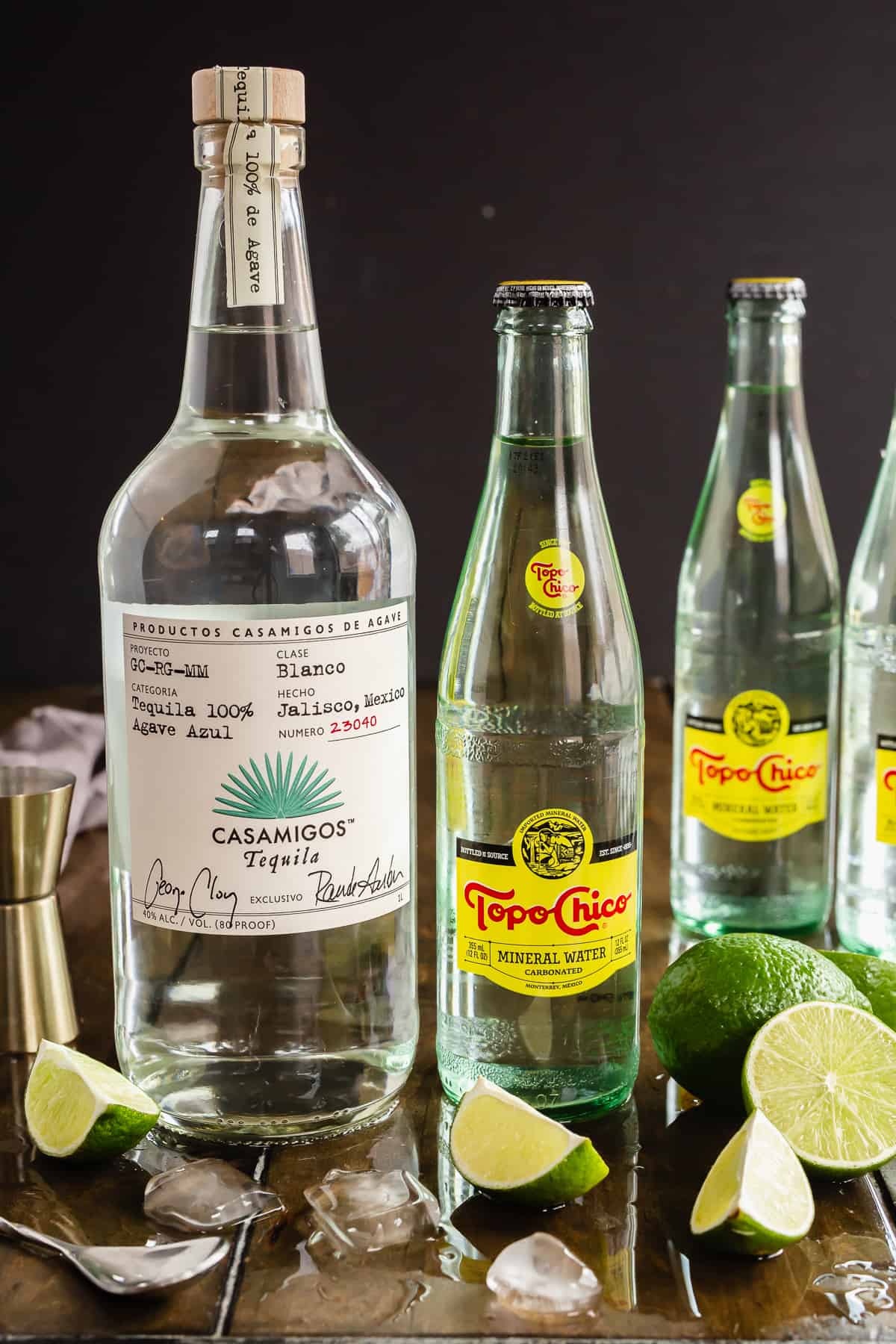 Casamigos Tequila, Topo Chico, and lime wedges.