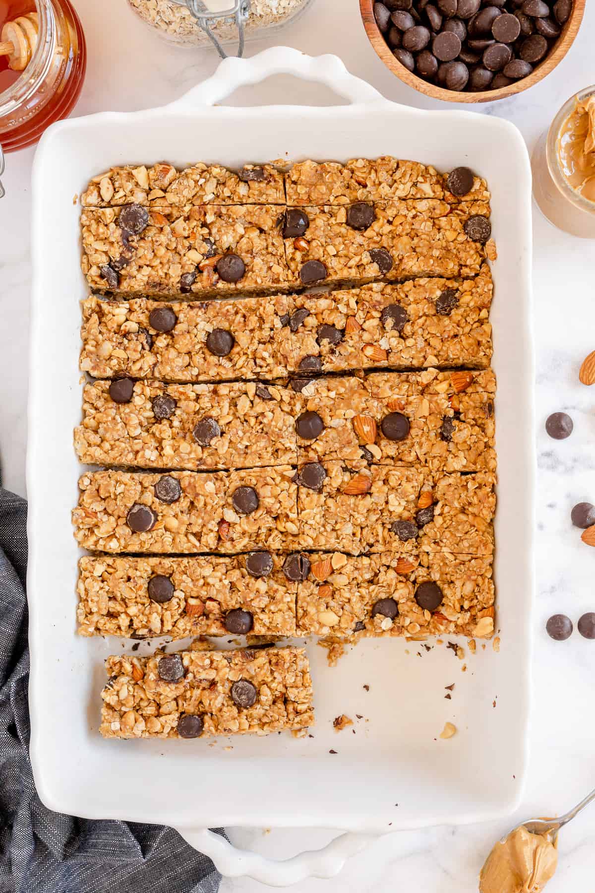 A dish full of granola bars with one missing.
