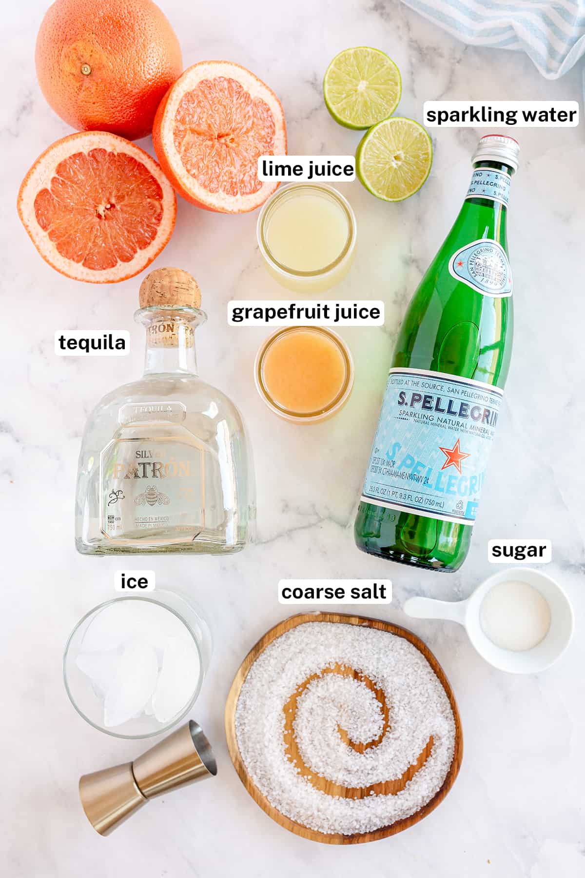 Tequila, Pellegrino and other ingredients to make a Paloma cocktail.