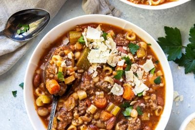 An over the top shot of two bowls of Hamburger Minestrone topped with Parmesan.