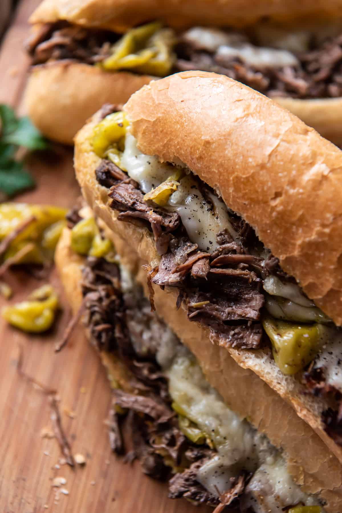 A close up of an Italian Beef Sandwich on a cutting board.