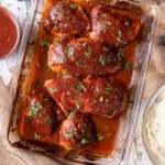 Oven BBQ Chicken in a baking dish on a cloth.